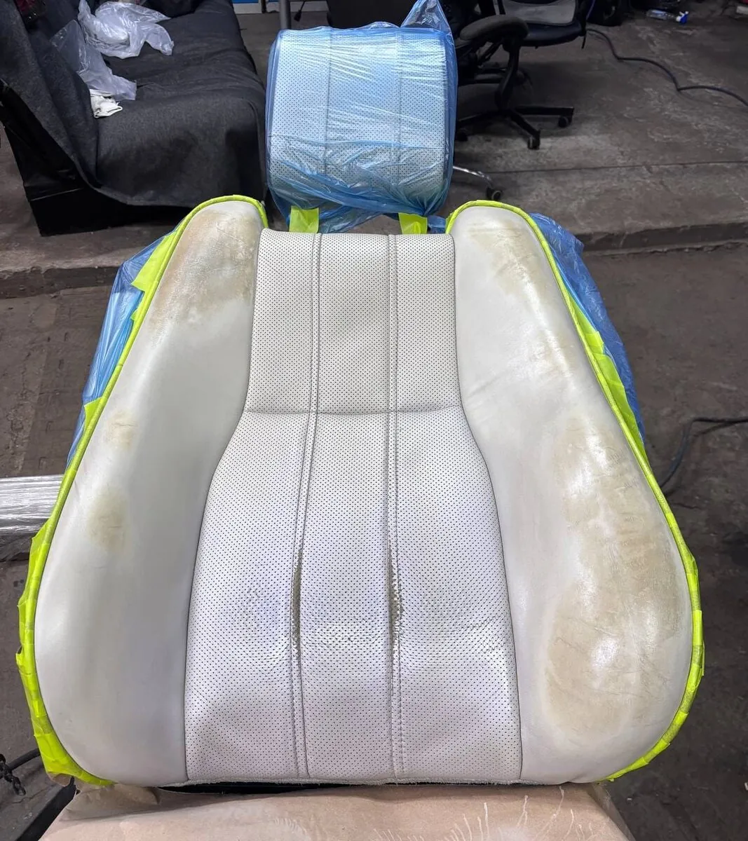 Worn light-colored car seat before restoration